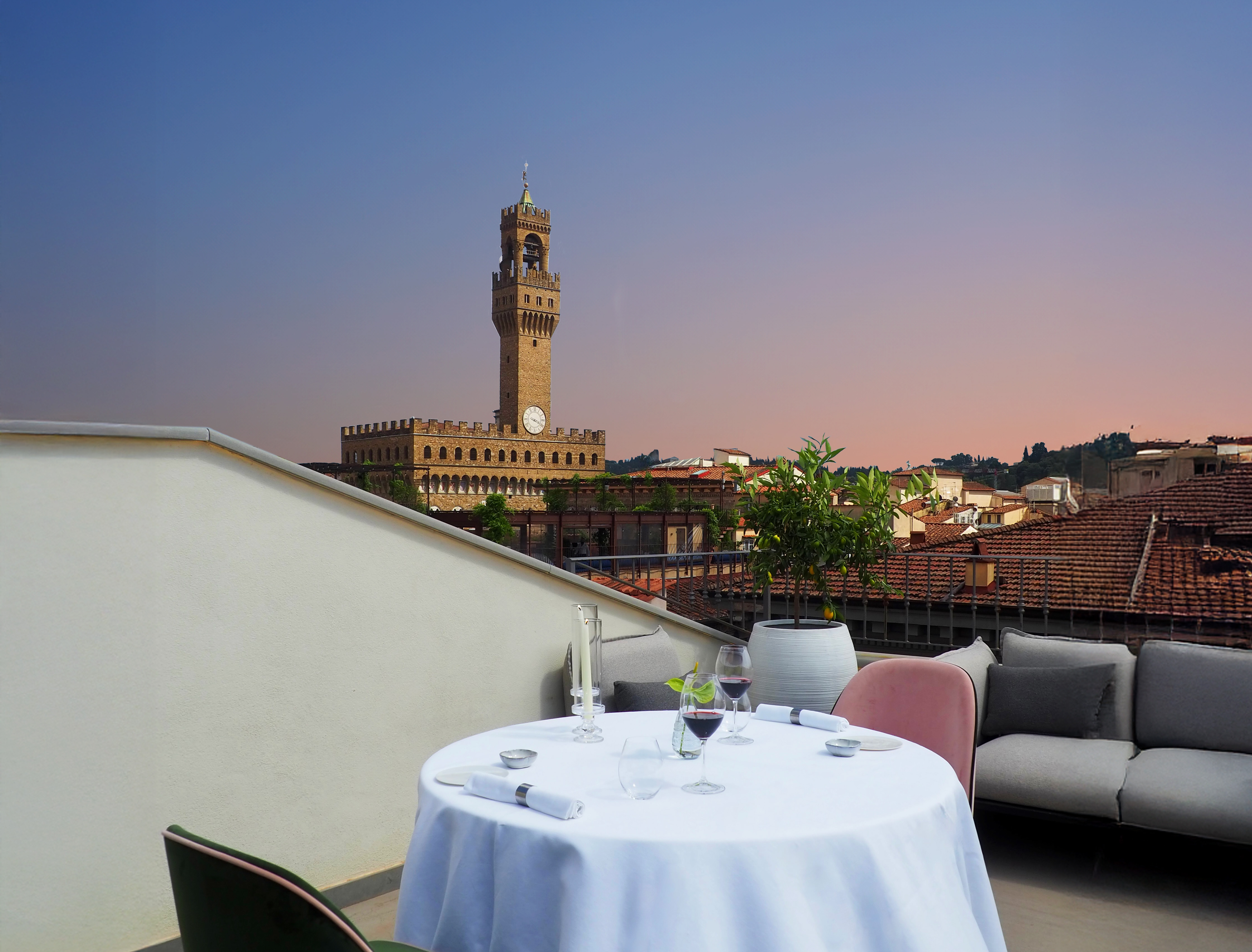 A rooftop dining table at La Gemma against a Florence sunset